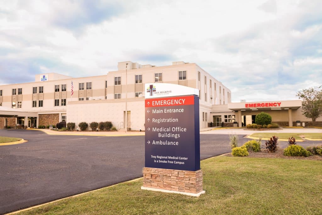 a building that has a sign on the side of a road